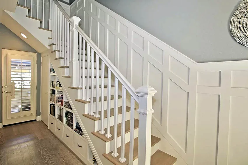 Under stairs storage with drawers and shelving with white wainscoting