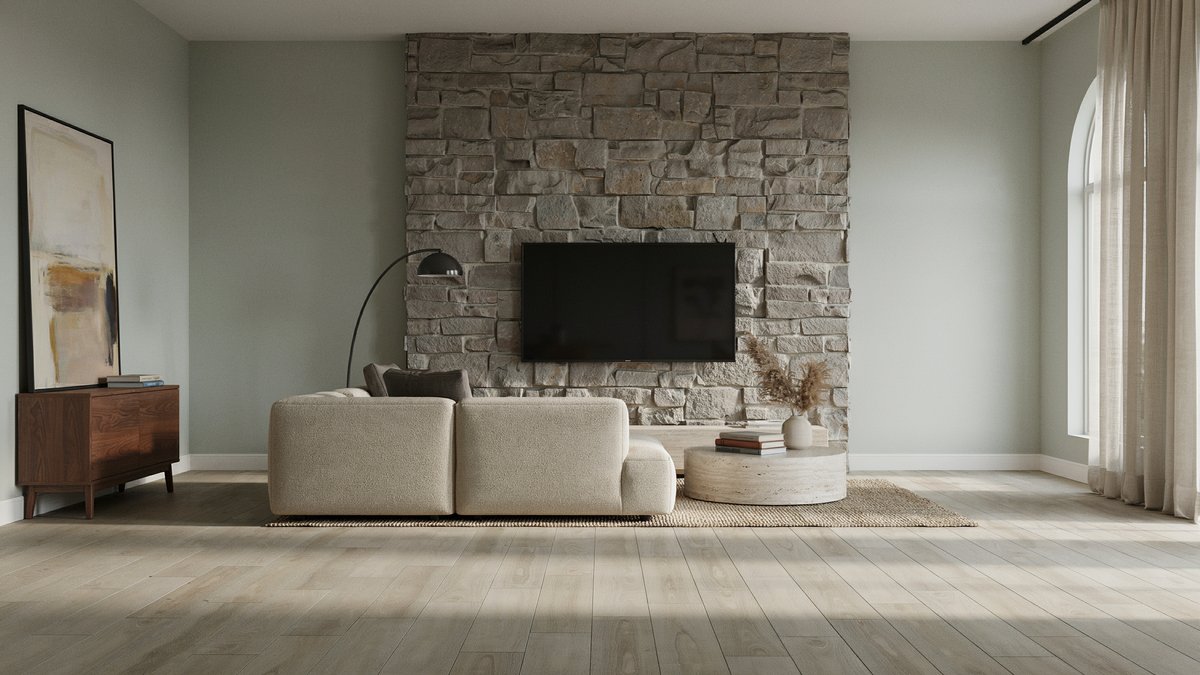 Stacked stone accent wall holds a television against soft green painted walls