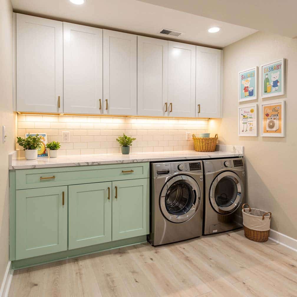 Finished basement laundry room with mint green lower cabinets and white uppers
