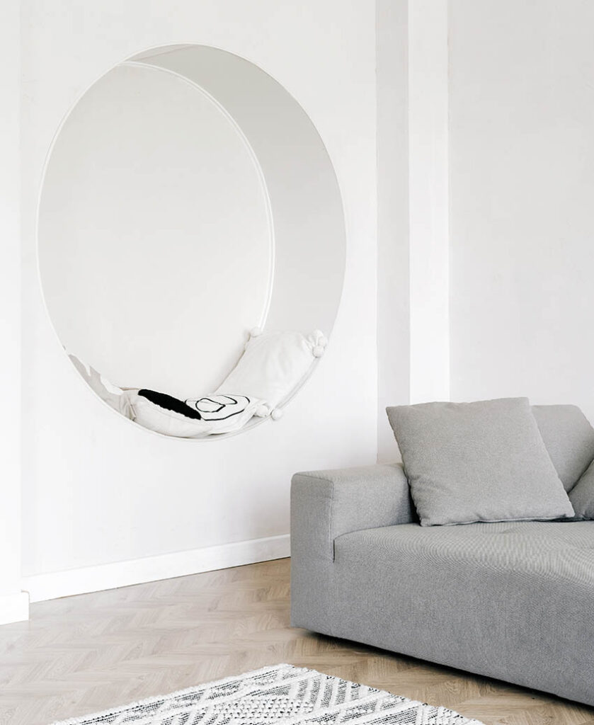 Custom circular wall niche in living room with cushions for sitting