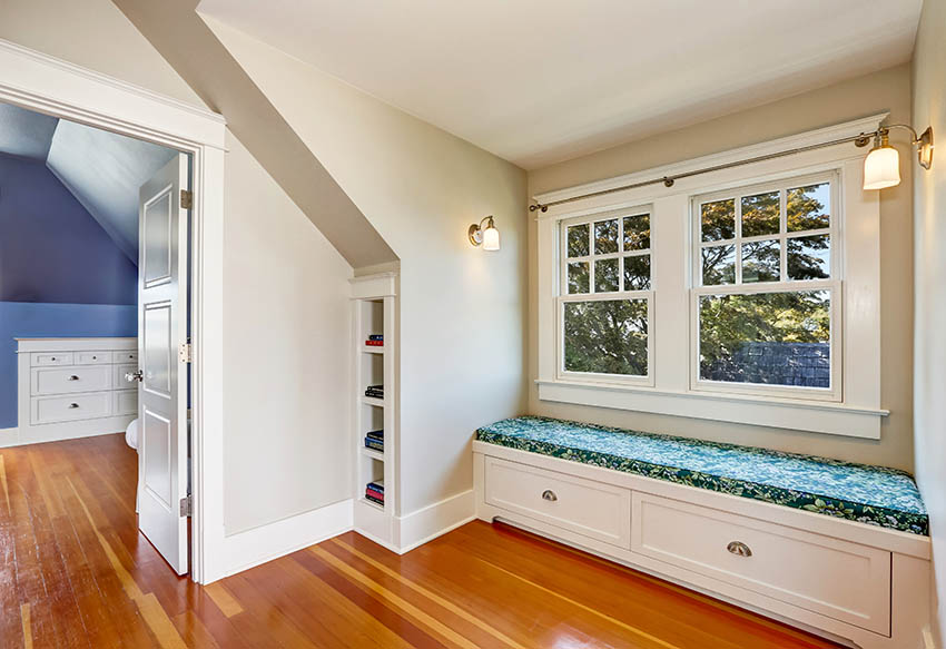 Girls bedroom with recessed bookshelves and window seat