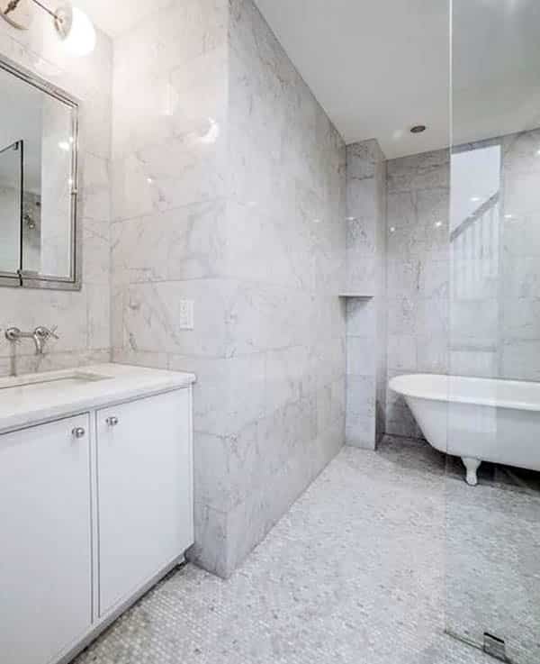 Clawfoot tub and white mosaic floor shower