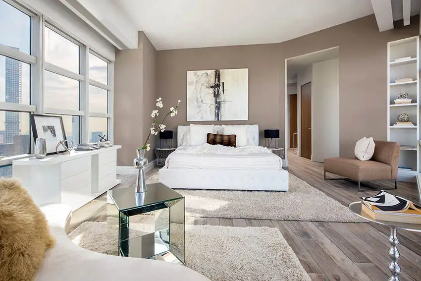 Bedroom painted in light brown and white bed and furniture