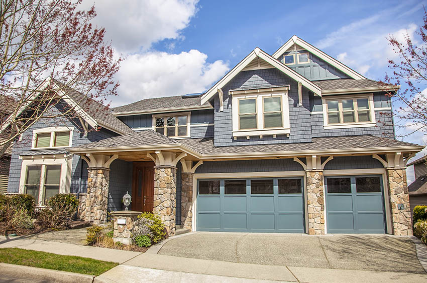 Contemporary home with blue garage 