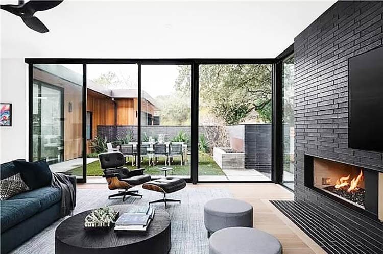 Contemporary living room with black brick fireplace wall