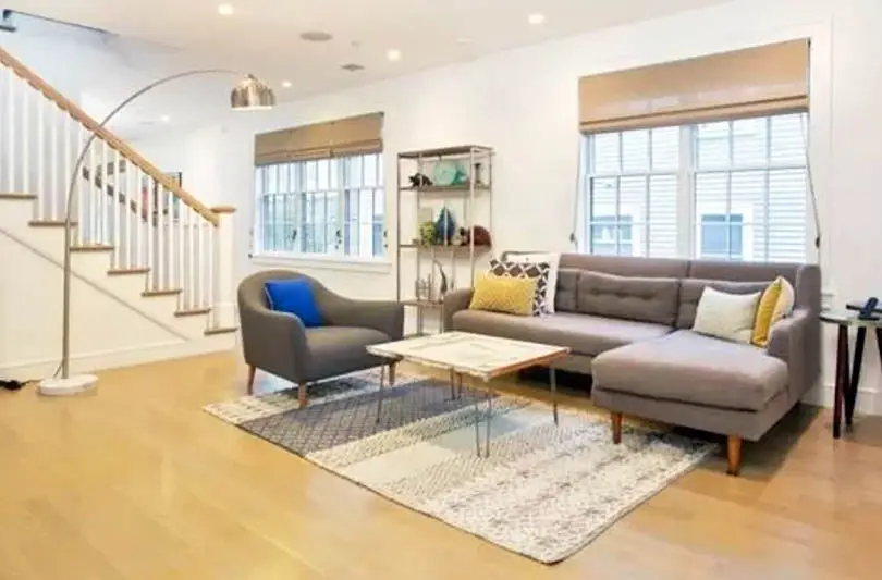 Metallic floor lamp, Roman shades and white staircase