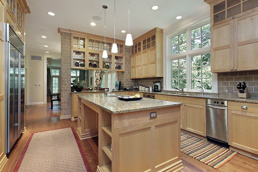 Craftsman kitchen with light wood cabinets and brown granite countertops