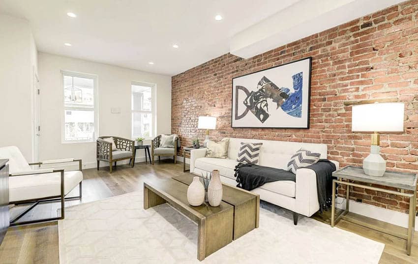 Exposed brick wall living room design with wood flooring and hanging picture