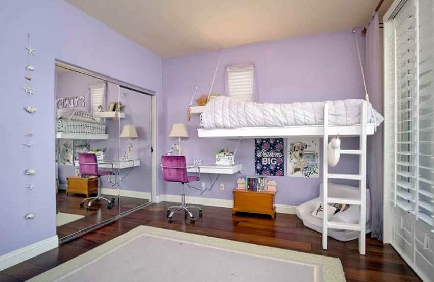 Girls purple bedroom with suspended bed and desk