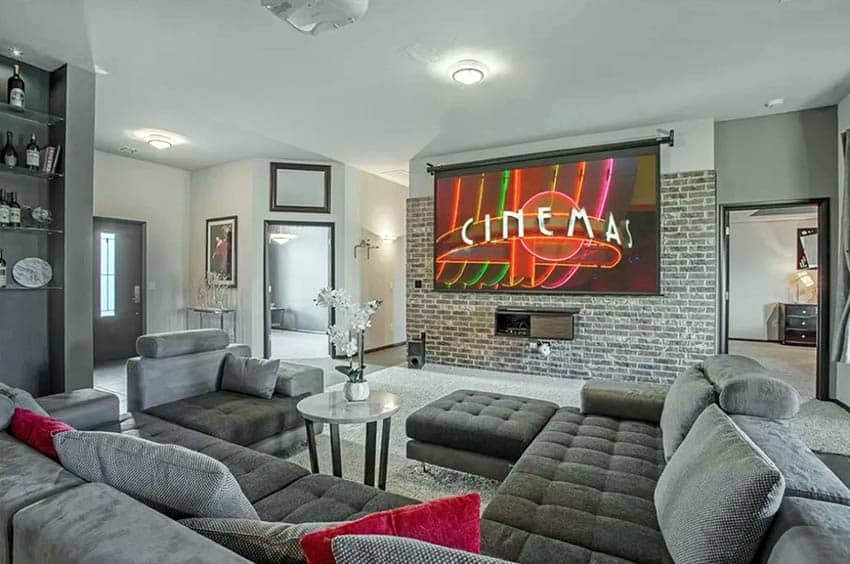 Gray brick wall in living room with projector tv large sectional sofa