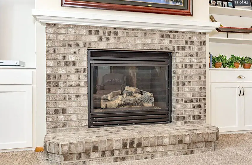 Graywashed fireplace and white walls