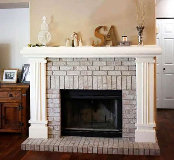 Fireplace with white column design and brown drawer