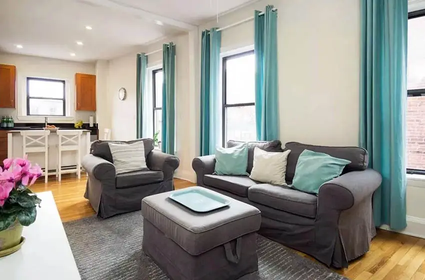 Dark brown furniture, turquoise pillows and curtains