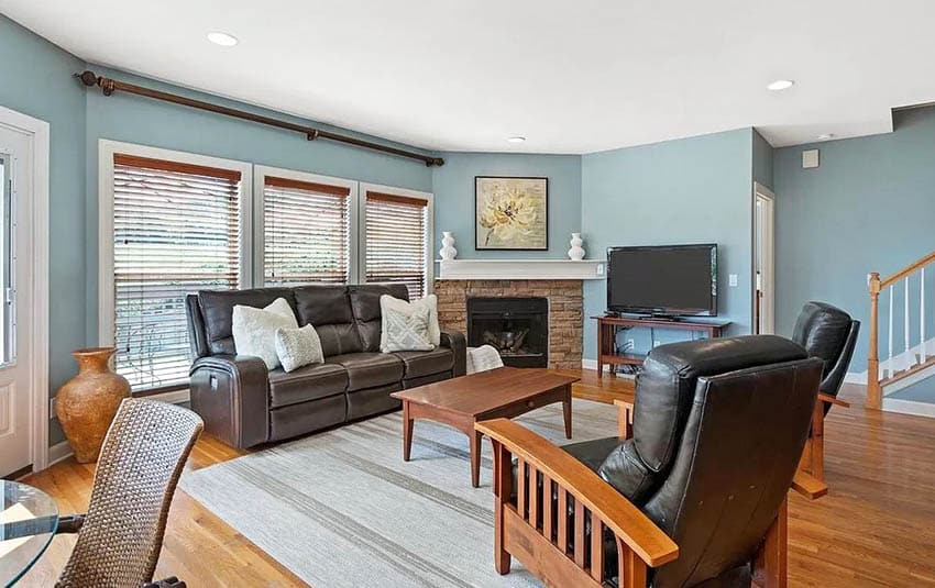 Room with tan fireplace, light sky blue walls and tan floors