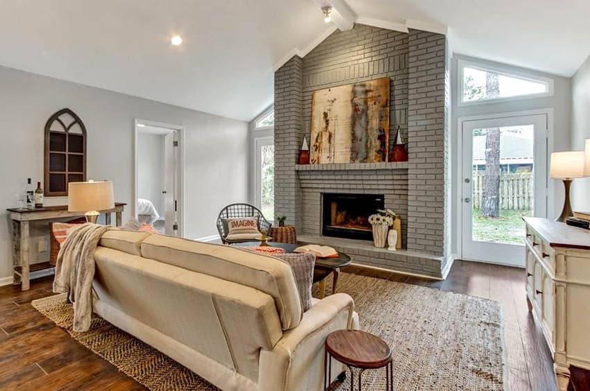 Living room with painted gray brick fireplace