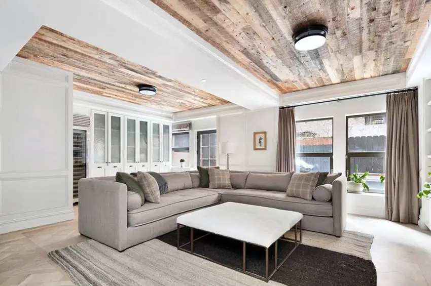 Room with wood paneling on the ceiling and white coffee table