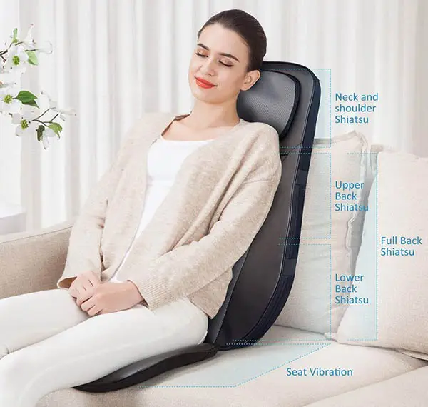 Woman sitting on a massage pad