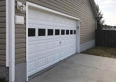 Sectional door with raised panels