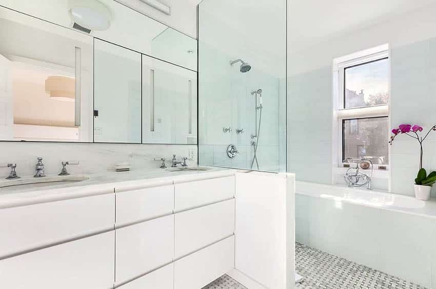 White bathroom with tub beside shower