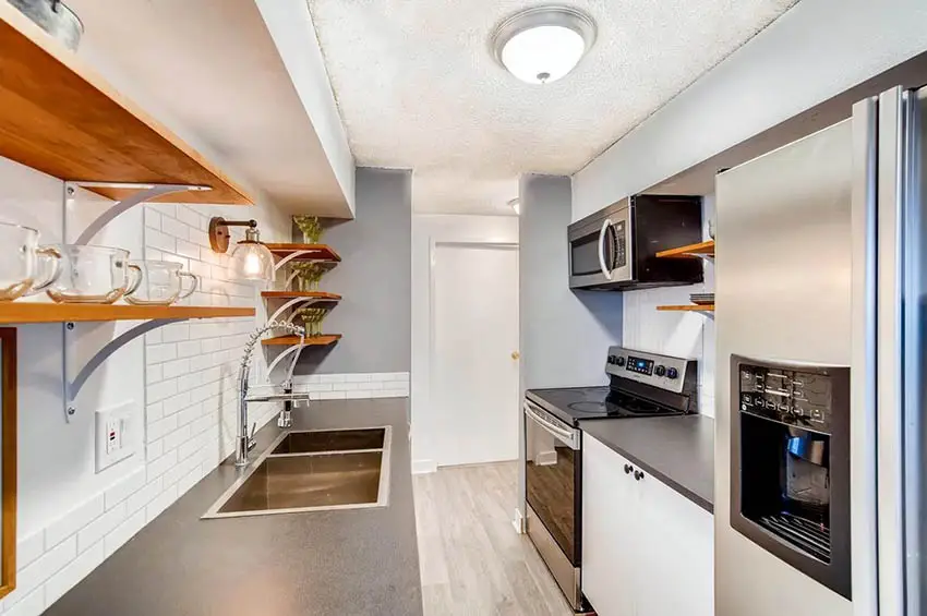 Galley kitchen style with white beams and sage green walls