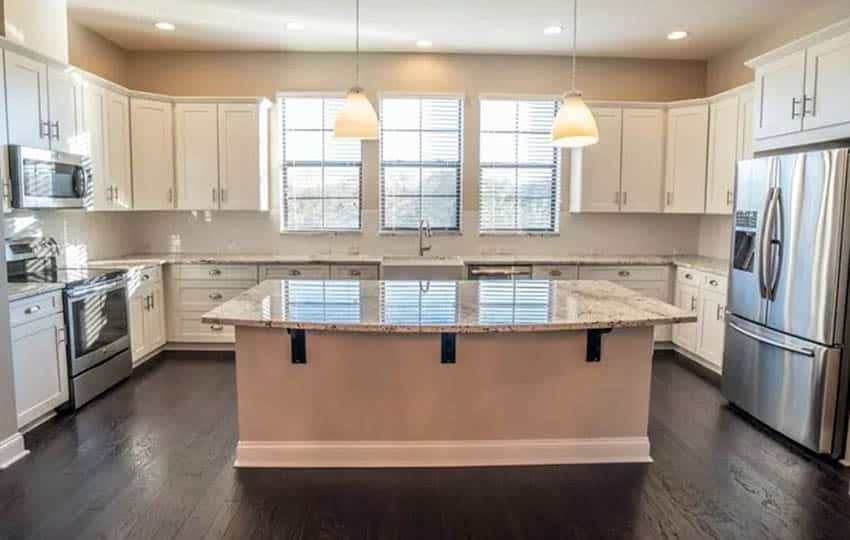 Kitchen island with corbels and white cabinets