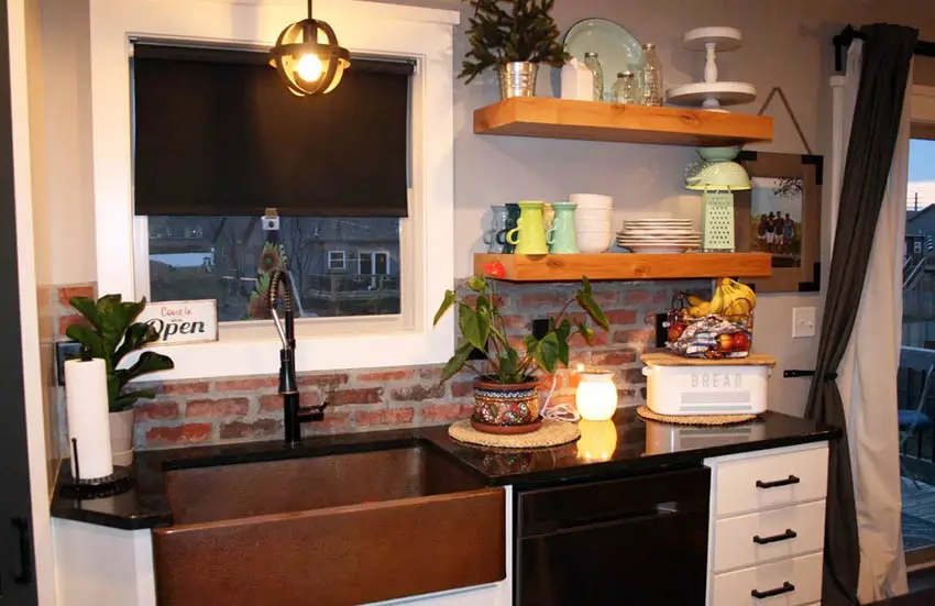 Kitchen with brick accent, Roman blinds and windows