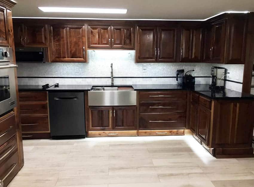 Kitchen remodel with added trim above cabinets with lighting