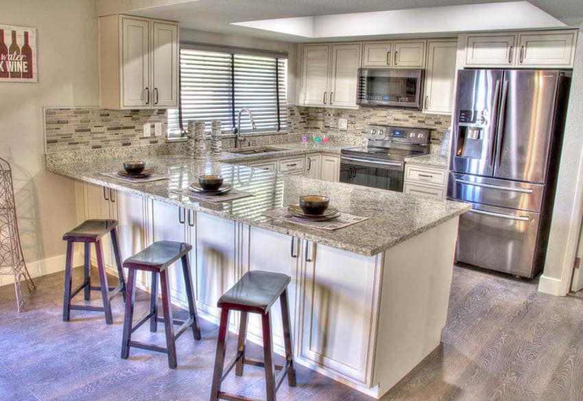 Kitchen with 4 inch backsplash granite countertops and mosaic tile backsplash