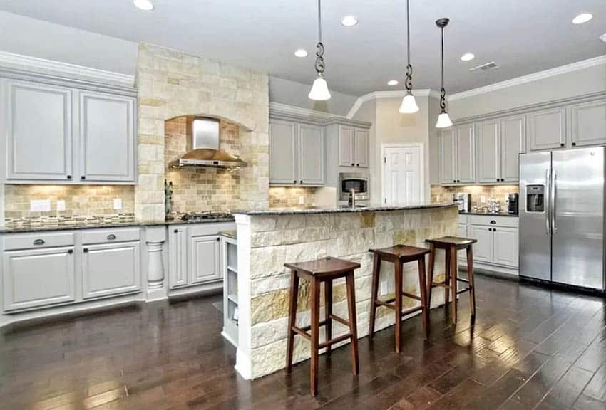 Kitchen with 4 inch backsplash with travertine tile above