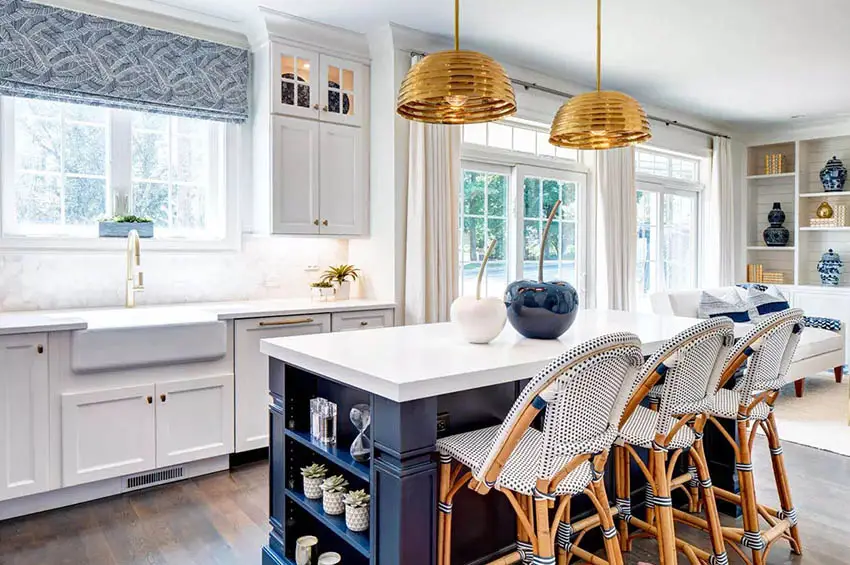 Kitchen with gold-finish chandelier, bamboo breakfast chairs and white curtains