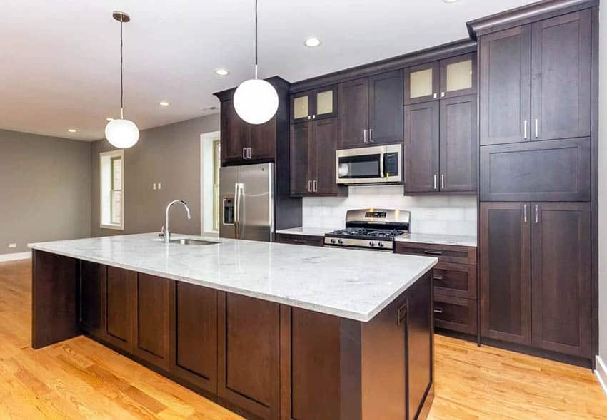 Kitchen with stained oak cabinets marble countertops