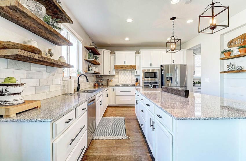 Kitchen with white cabinets and reclaimed wood open shelving with decor pieces