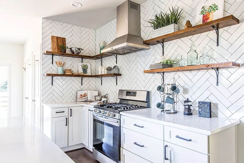 Kitchen with white cabinets open shelves herringbone tile backsplash
