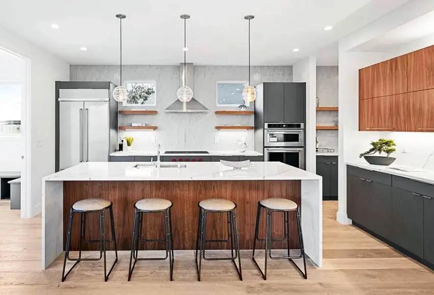 Kitchen with gray and brown cabinets and floating shelves with under-cabinet lighting