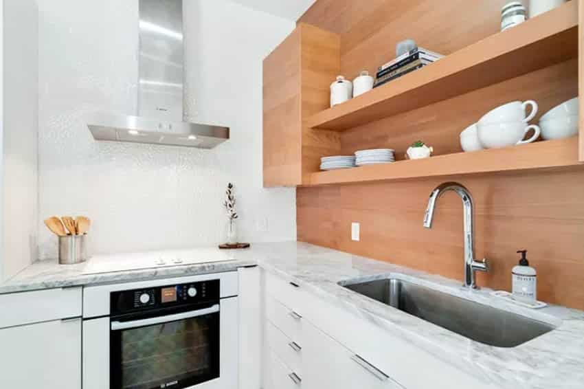 Small modern kitchen with wood open shelving and white base cabinets