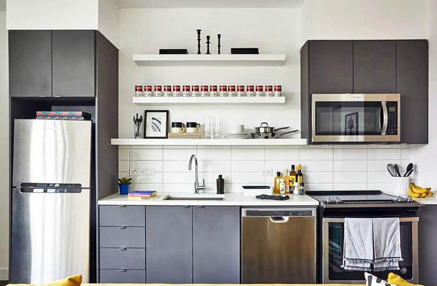 Kitchen with brown black cabinets, handleless drawers and Campbell soup decor