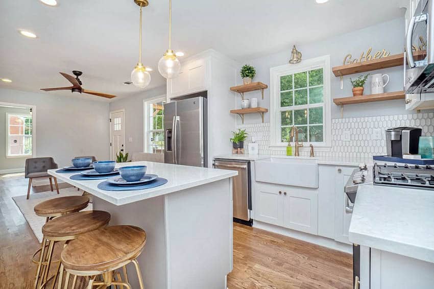 White kitchen open shelves tile backsplash and dining island with bar stools