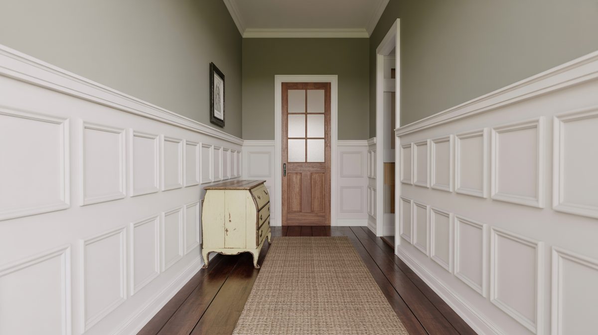 Long narrow hallway with white flat panel wainscoting on both walls, sage green upper walls, distressed cream bombe chest, and glass-pane wood door