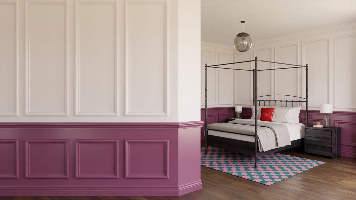 Modern bedroom with two-tone panels in bold berry-purple below and cream above, black iron four-poster bed, and pink-and-teal checkerboard area rug