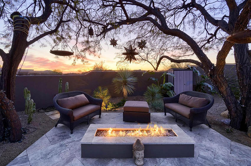 Backyard patio with fire pit and desert landscaping