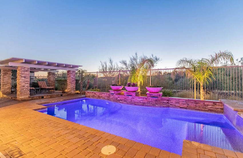 Backyard pool with accent lighting