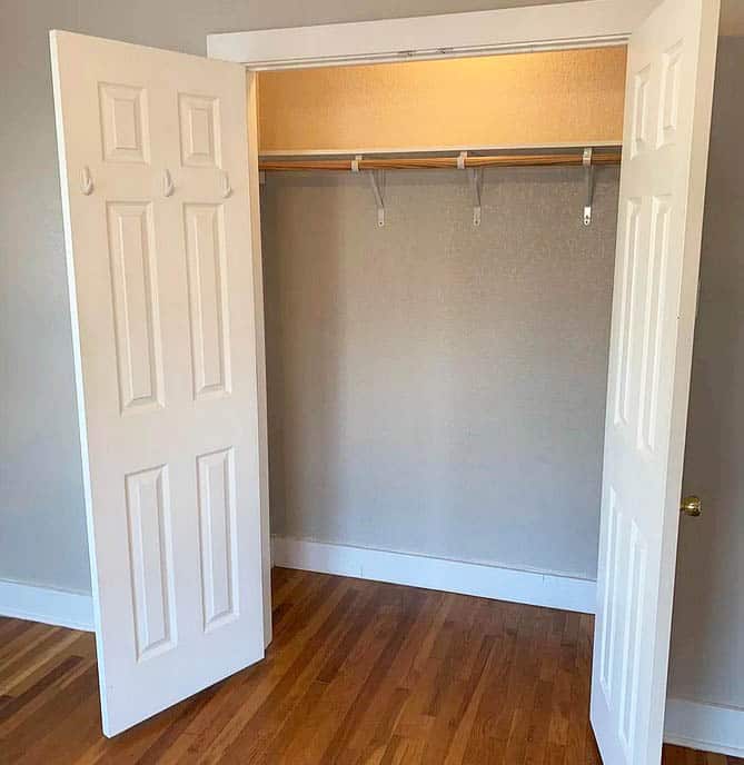 Bedroom closet with double doors and closet rod
