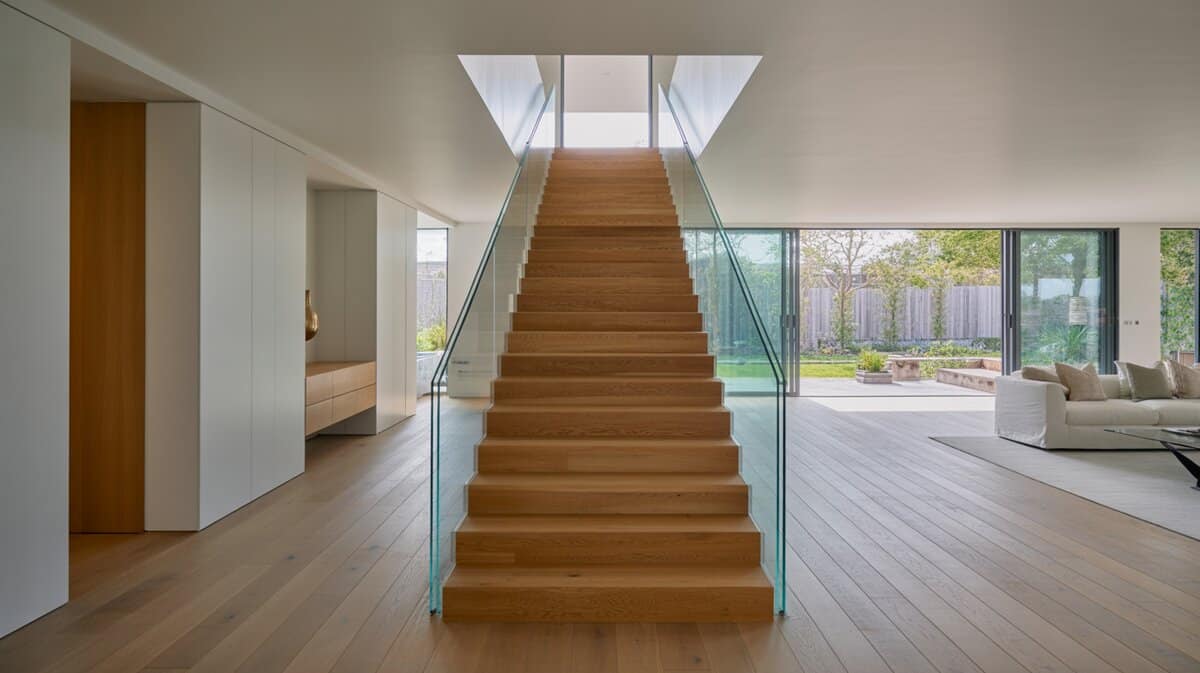 Contemporary home with floating oak staircase and full glass panel balusters and floor-to-ceiling windows
