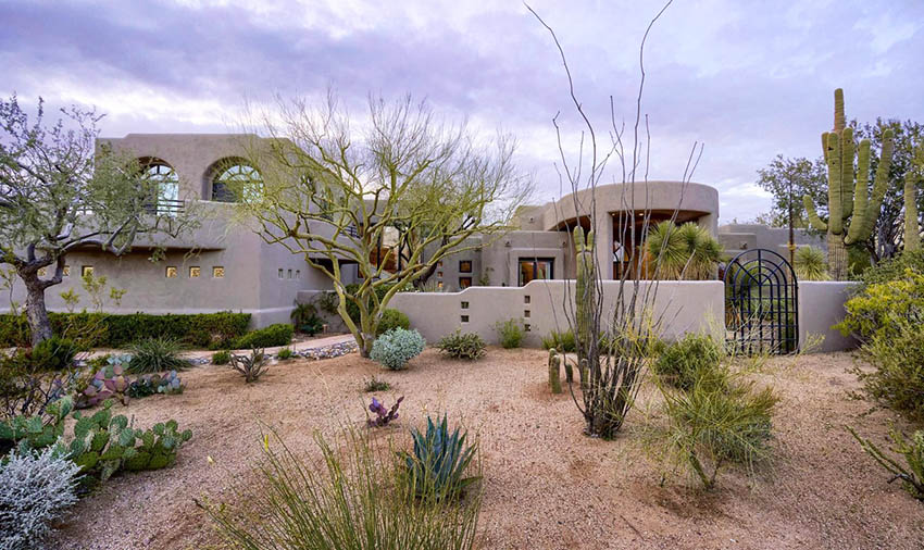 Contemporary home with desert shrubs landscape