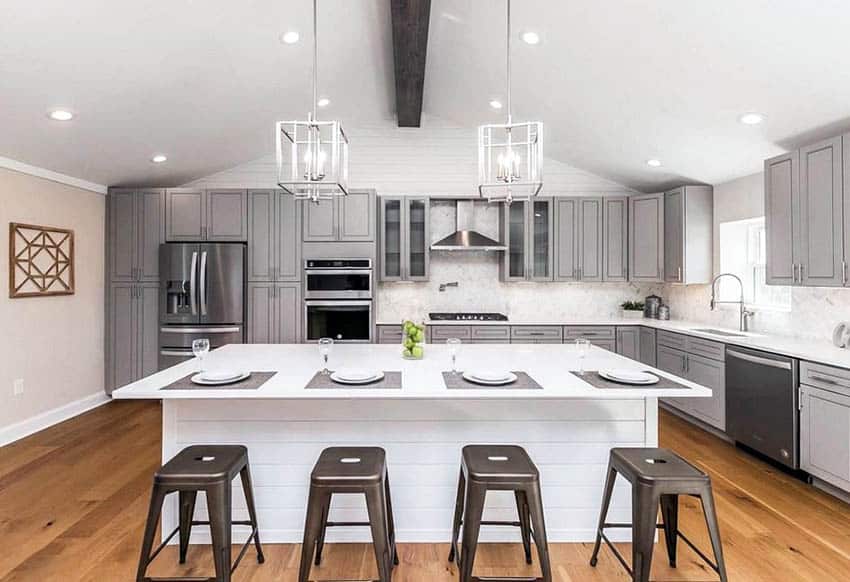 Contemporary kitchen with gray cabinets, silver door hardware and white shiplap island