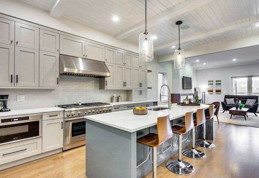 Contemporary kitchen with light gray cabinets dark gray island