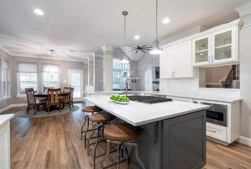 Contemporary kitchen with wood look tile flooring and white cabinets