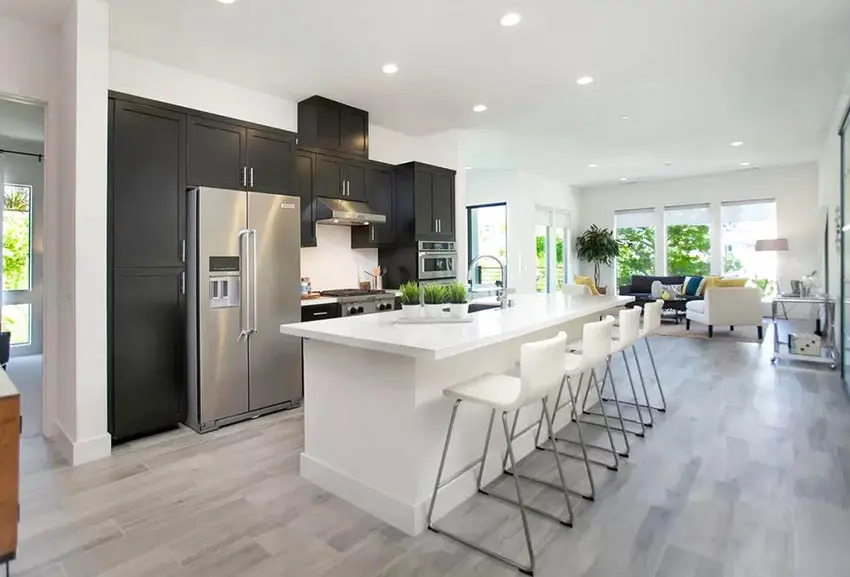 Contemporary kitchen with wood style porcelain tile flooring dark cabinets white island