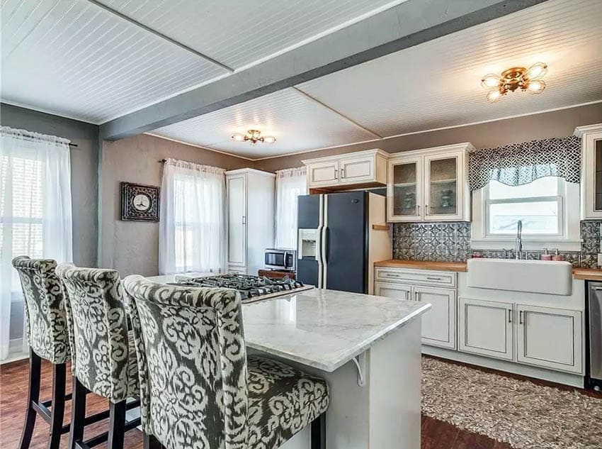 Country kitchen with beadboard ceiling and distressed cabinets