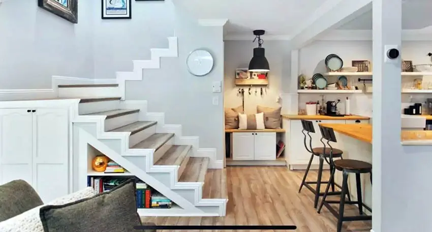 Custom storage space under stairs with shelves and cabinet